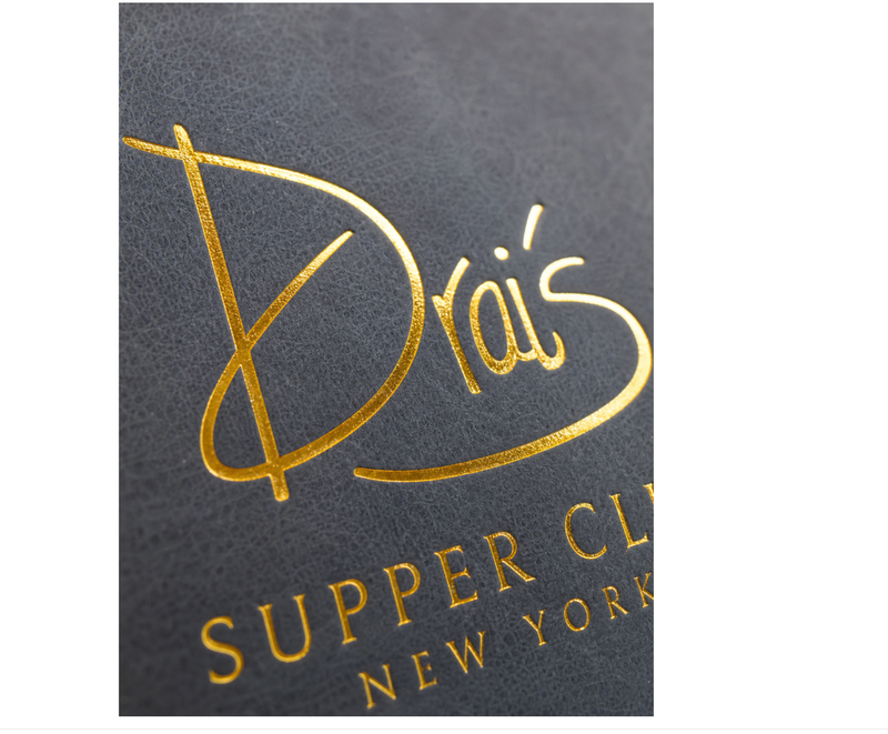 Gold foil hot stamping close-up on dark textured notebook cover